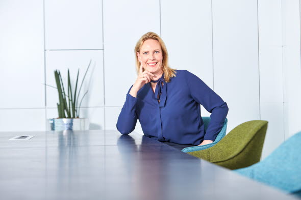 Picture shows a woman sitting at a table